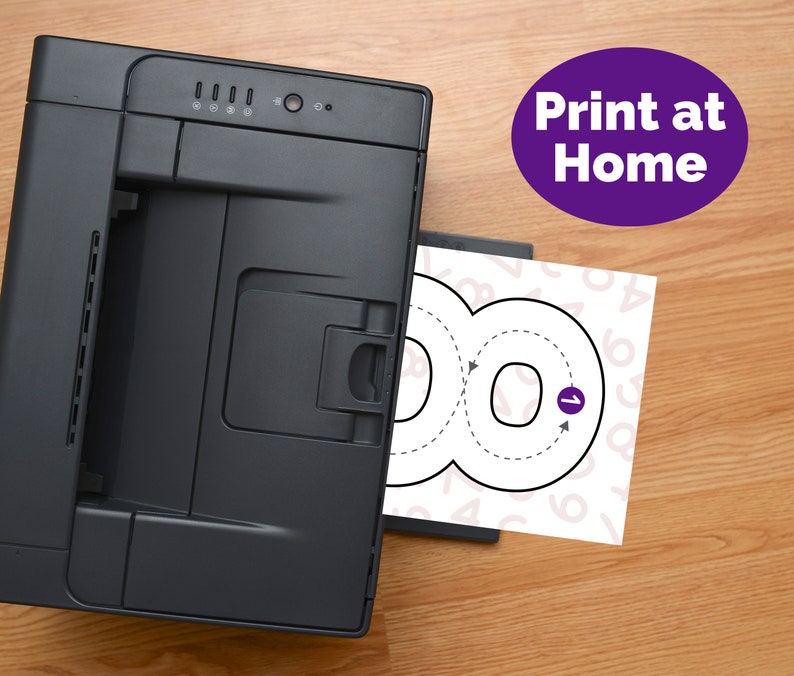 May include: A black desktop printer outputting a white sheet of paper featuring a large black outline of the number eight with directional arrows and a purple circle containing the number one. A purple oval with the text Print at Home is visible.