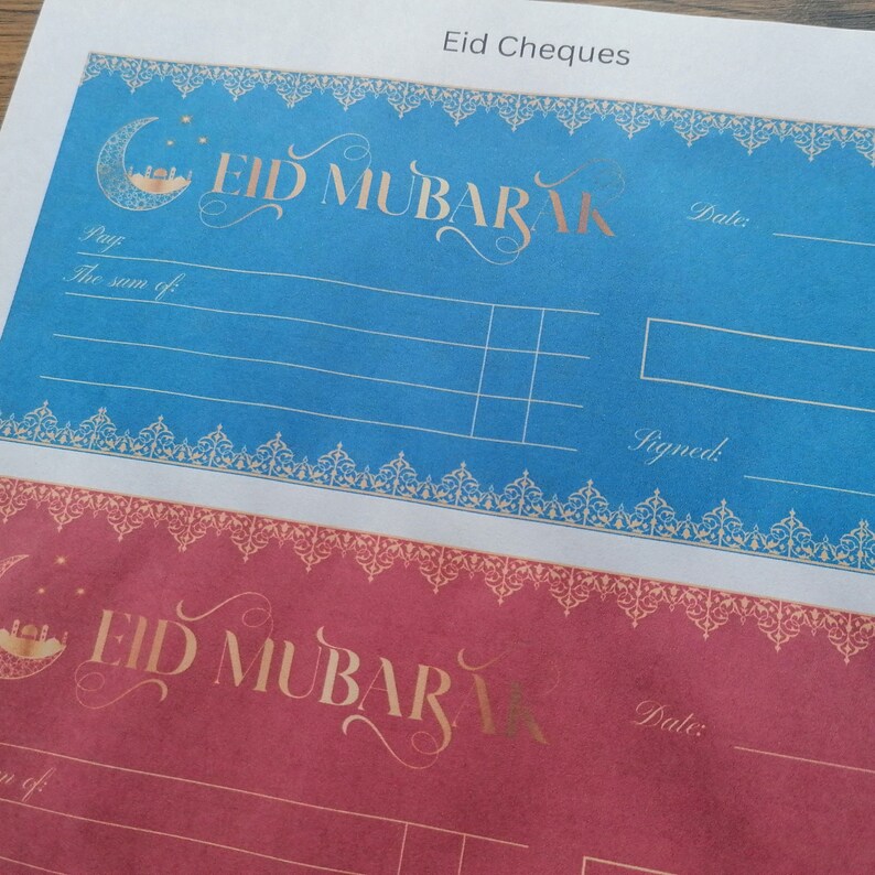 May include: Two printable Eid Mubarak gift cheque templates. The top template is blue with gold accents and the bottom template is red with gold accents. Both templates have a crescent moon and star design with the words "Eid Mubarak" in gold lettering.