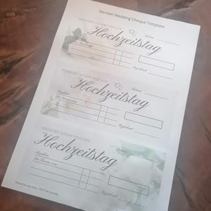 May include: Three German wedding cheque templates printed on white paper. The templates feature the word "Hochzeitstag" in elegant script, along with spaces for details. Floral accents and the text "Personal use only - NOT for re-sale" are also visible.