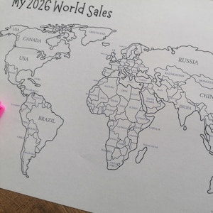 May include: A black and white printed world map on paper with the text My 2026 World Sales at the top. The map features outlined country borders and labels for various nations including Canada, USA, Brazil, Russia, China, and India.