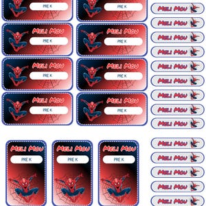 May include: A sheet of rectangular and oval adhesive labels featuring a red and black gradient background with a spiderweb pattern and a graphic of a superhero. Each label displays the text MELI MOU and PRE K in a white rectangular field.