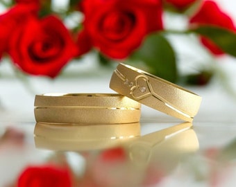 Gouden trouwringset: minimalistische hartpaarringen