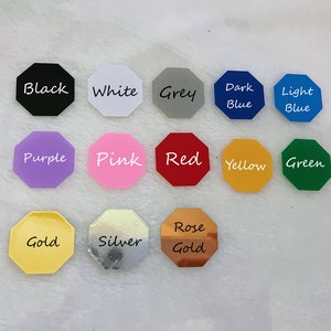 May include: A collection of 14 octagon-shaped color samples, each with a different color and the color name written in white. The colors include black, white, grey, dark blue, light blue, purple, pink, red, yellow, green, gold, silver, and rose gold.