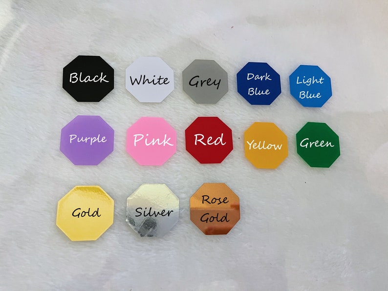 May include: A collection of 14 octagon-shaped color samples, each with a different color and the color name written in white. The colors include black, white, grey, dark blue, light blue, purple, pink, red, yellow, green, gold, silver, and rose gold.