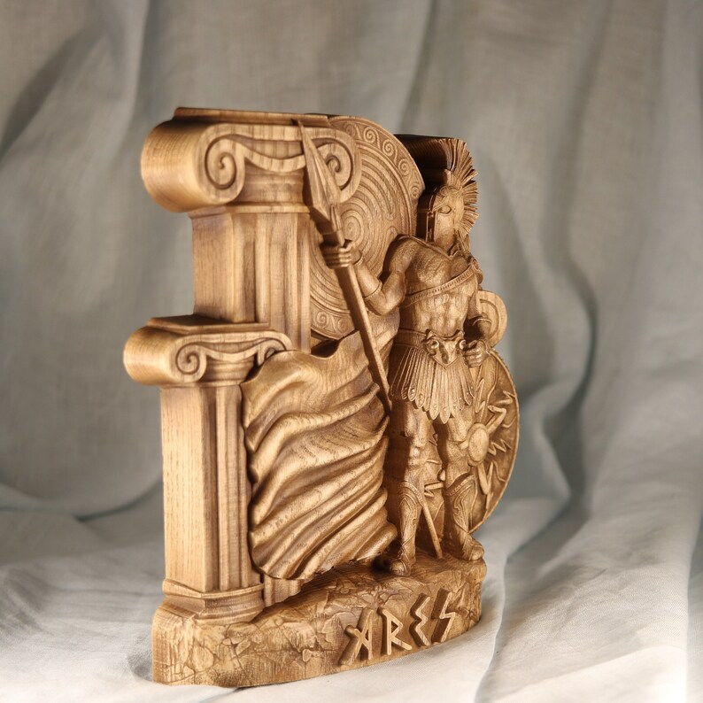 Side view of a dark wood Ares statue panel, showcasing detailed relief carving of the Greek god of war with spear and shield, classic Ionic columns, and "ARES" inscription.