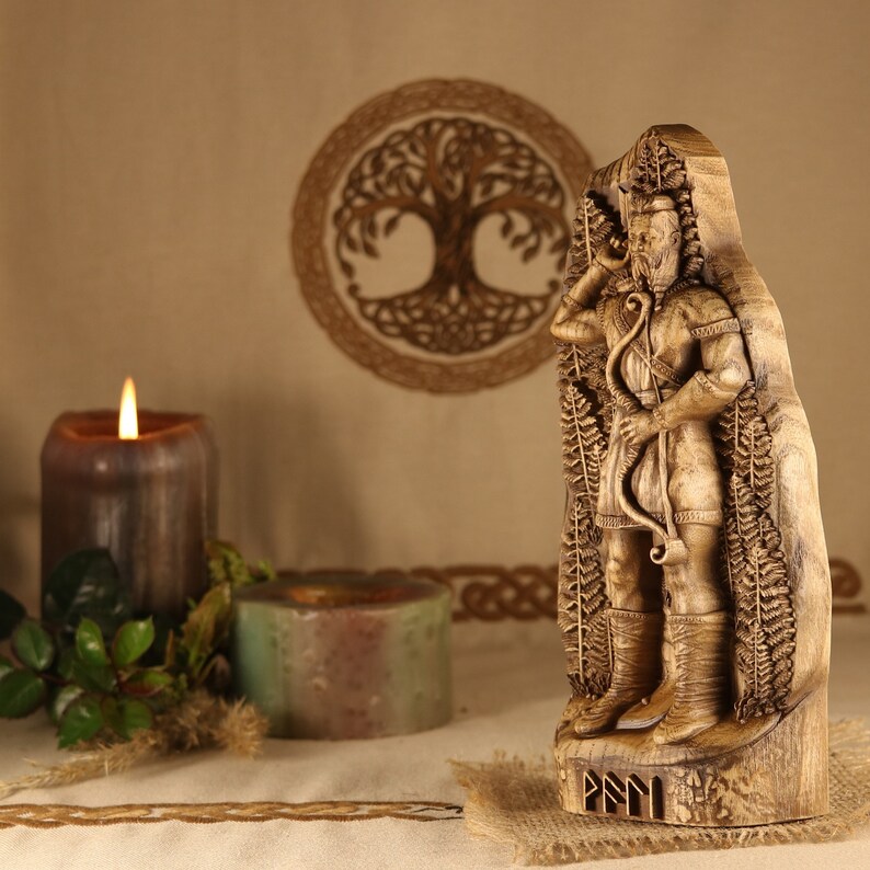 May include: A wooden carving of a Norse god, possibly Odin, holding a bow and arrow. The carving is surrounded by intricate details of leaves and branches. The carving is on a wooden base with the word "Fylgja" inscribed on it.