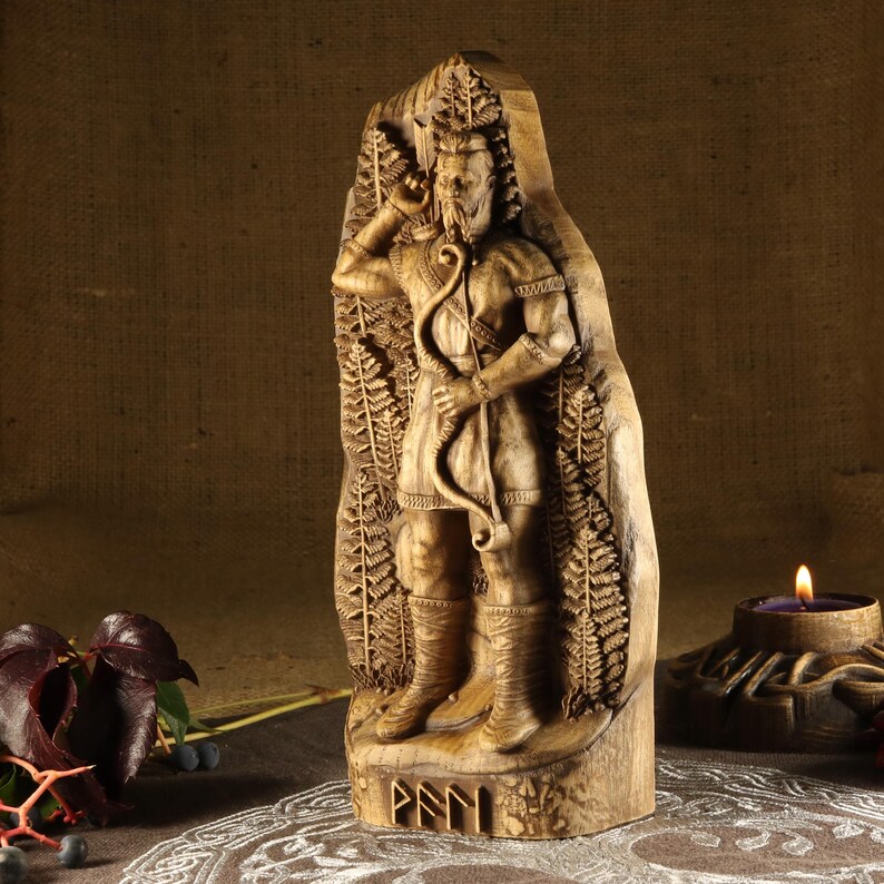 May include: A wooden carving of a Norse god holding a bow and arrow. The carving is detailed and intricate, with the god's beard and hair flowing in the wind. The carving is set against a background of ferns and the god's name, "Fenn", is carved at the bottom.