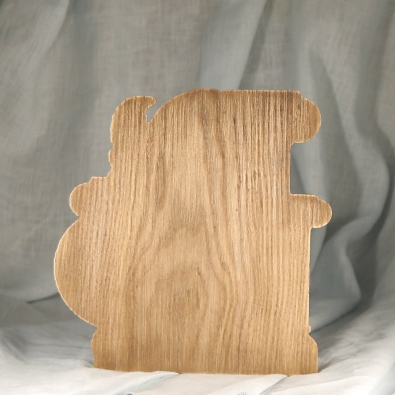 The flat back side of the wooden Ares statue, showcasing the smooth natural wood grain texture available for custom laser engraving and personalization.