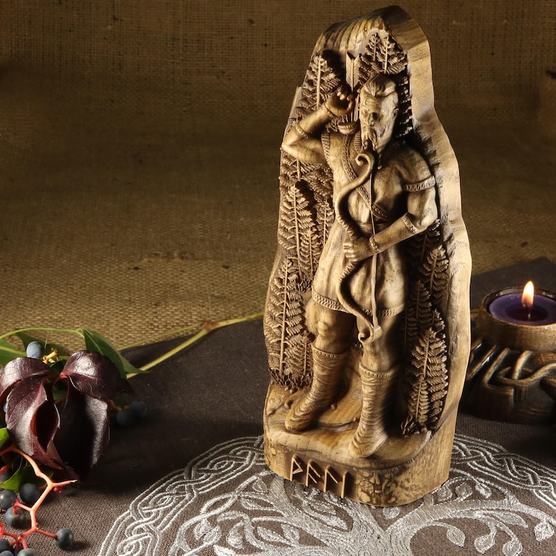 May include: A wooden carving of the Norse god,  Fenn, holding a bow and arrow. The carving is detailed and shows Fenn standing in a forest setting. The carving is inscribed with the word "Fenn" at the bottom.