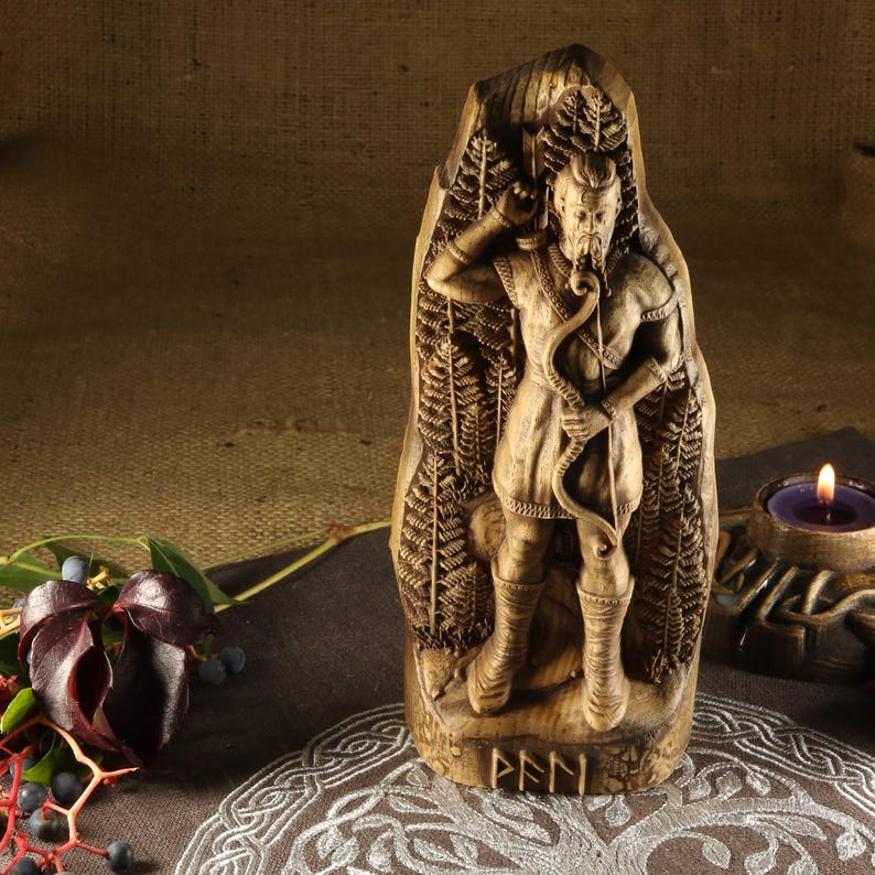 May include: A wooden carving of a Norse god, possibly Odin, with a beard and holding a bow and arrow. The carving is surrounded by a fern pattern and the word "FEN" is inscribed at the bottom.