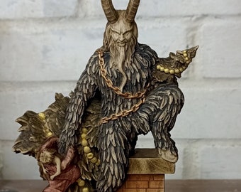 May include: A detailed figurine of Krampus, a horned figure from Alpine folklore, with a long beard and fur-like texture. He is adorned with a gold chain and holds a Christmas stocking. The figurine is perched on a brick chimney.