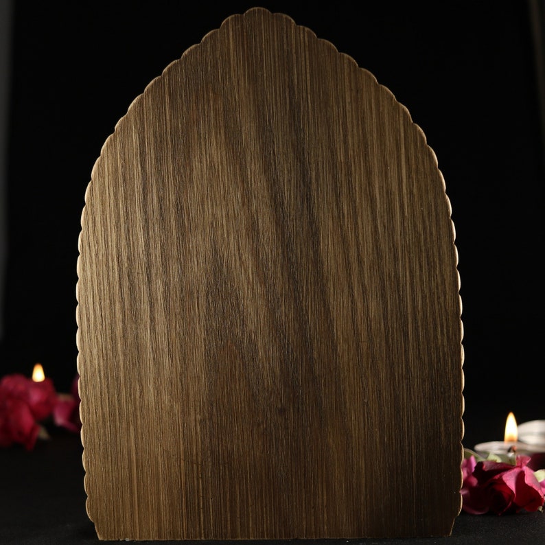 May include: A wooden plaque with a scalloped edge, perfect for displaying a message or artwork. The plaque is a dark brown color and has a natural wood grain.