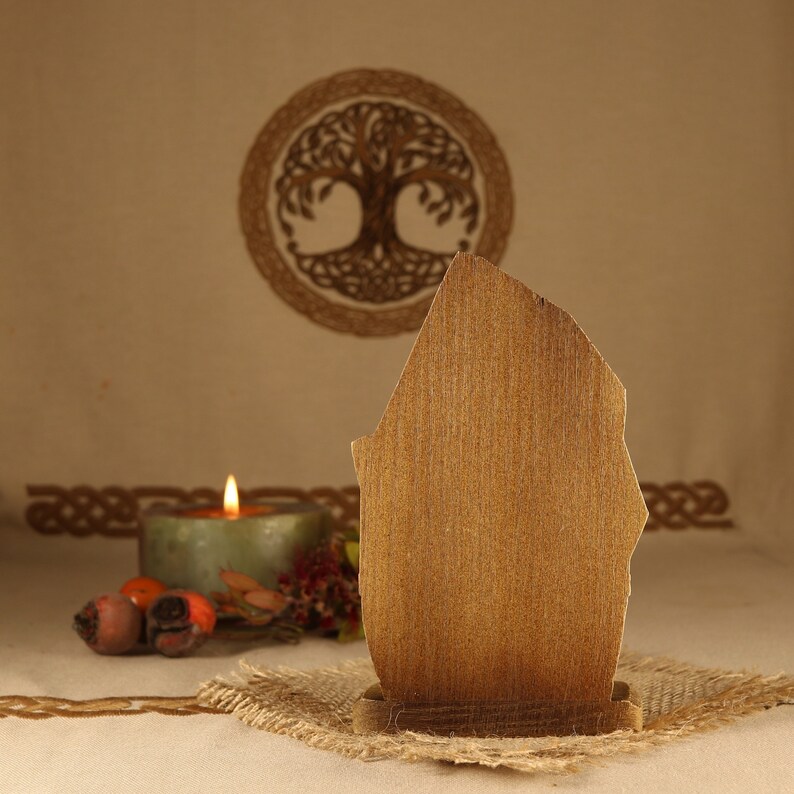 May include: A wooden sign with a rustic brown finish, standing on a burlap base. The sign is blank and ready to be personalized. The sign is in front of a background with a Celtic knot design.
