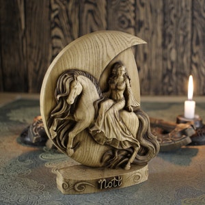 May include: A wooden carving of the Norse goddess Nott riding a horse, depicted as a crescent moon. The carving is detailed and features a woman in a flowing gown riding a horse with a long mane. The carving is on a wooden base with the word "Nott" inscribed on it.