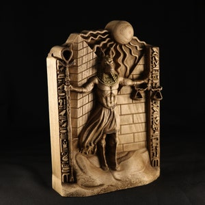 May include: A wooden sculpture of an Egyptian god with a jackal head, holding a staff and scales. The sculpture is carved with intricate details and hieroglyphics.