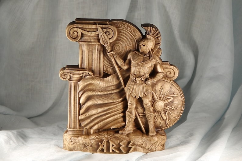 A wooden sculpture of the Greek god Ares, depicted as a warrior holding a spear and shield next to Greek columns, pagan altar decor.