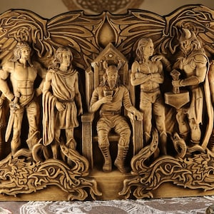 May include: A wooden carving depicting nine figures from Norse mythology. The figures are carved in relief and are arranged in a semi-circle around a central figure. The central figure is Odin, the god of wisdom, war, and death. He is seated on a throne and holding a drinking horn. The other figures are Thor, the god of thunder; Freya, the goddess of love and beauty; Heimdall, the watchman of the gods; Loki, the trickster god; Baldr, the god of light; Hodr, the god of darkness; and the two wolves, Geri and Freki.