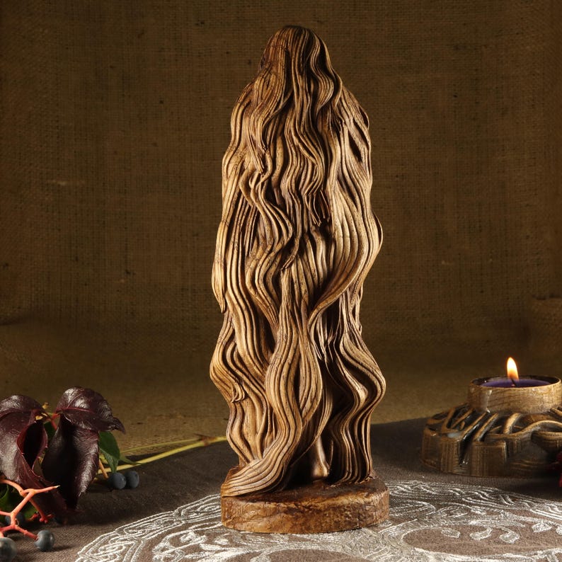 May include: A wooden sculpture of a woman with long, flowing hair. The sculpture is carved in a realistic style and has a natural wood finish.