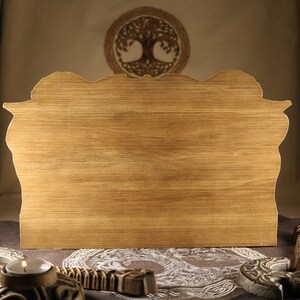 May include: A wooden sign with a carved design, featuring a light brown wood grain. The sign is blank and ready for personalization.