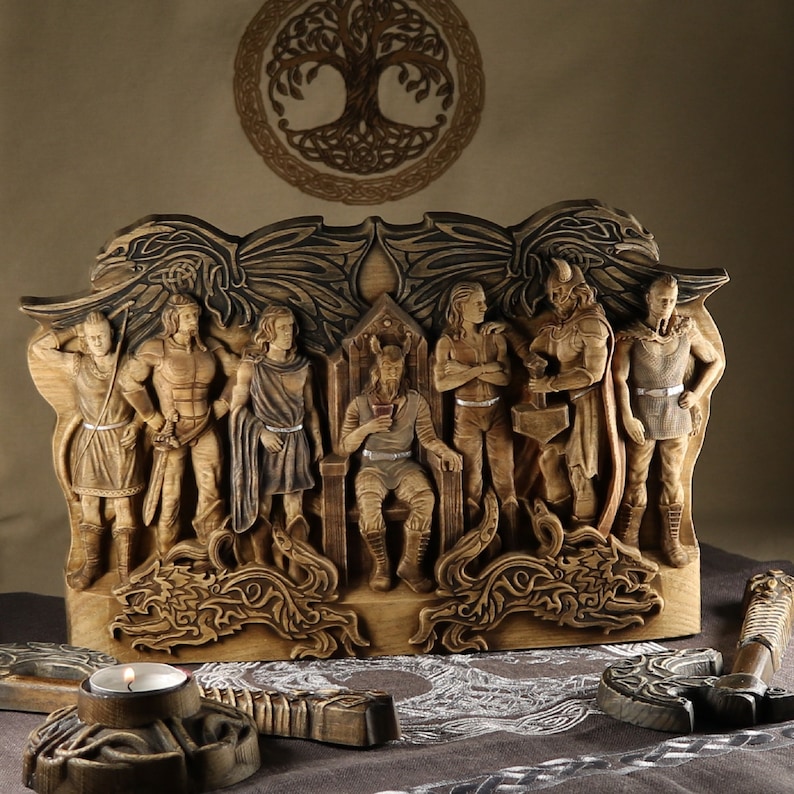 May include: A wooden wall sculpture depicting nine figures, including a central figure seated on a throne. The figures are carved in detail and have a rustic, aged appearance. The sculpture is set against a background of a tree of life design.