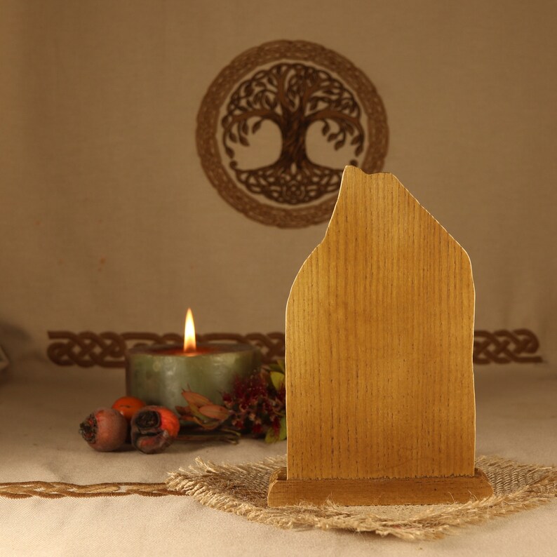 May include: A wooden sign with a rustic, weathered finish. The sign is blank and ready to be personalized. It is sitting on a burlap mat in front of a candle and a Celtic knot design.