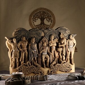 May include: A wooden wall sculpture depicting the Norse gods, Odin, Thor, and others. The sculpture is carved in detail and features a tree of life design.