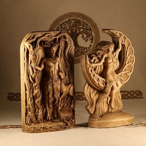 May include: Two wooden carvings of deities. The first carving depicts a male figure with antlers, holding a staff and standing in a forest setting. The second carving depicts a female figure riding a crescent moon, with her hair flowing behind her.