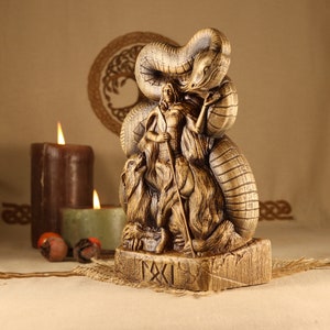 May include: A wooden statue of a Norse goddess with a snake wrapped around her, holding a spear. The statue is carved with intricate details and has a rustic finish.