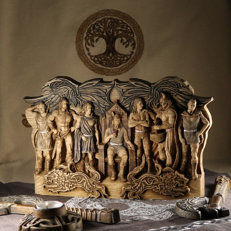 May include: A wooden wall hanging featuring a group of carved figures, including a king on a throne, surrounded by warriors and a tree of life design. The figures are intricately detailed and have a rustic, aged appearance.