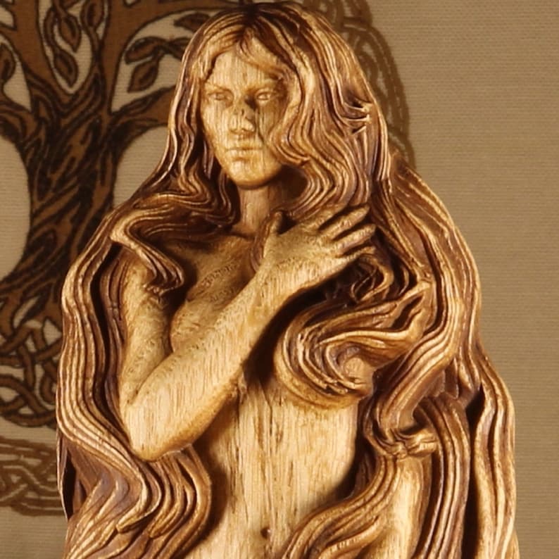 May include: A wooden sculpture of a woman with long flowing hair. The sculpture is carved in a detailed style, with the woman's hair flowing down her back and around her shoulders. The sculpture is painted in a light brown color, giving it a natural wood finish.