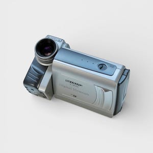 May include: A silver and black Sharp VL-NZ100 Digital Viewcam. The camcorder features a lens on the left and a silver body with the text "Digital Viewcam". The device is set against a white backdrop.