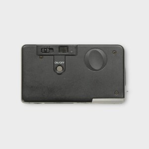 May include: A black rectangular camera with a flash and an on/off button. The camera has a small lens and a film advance wheel. The camera is a vintage model.