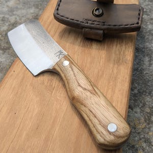 Handmade 17 cm fulltang cleaver with Ash Wood handle and leather sheath.
