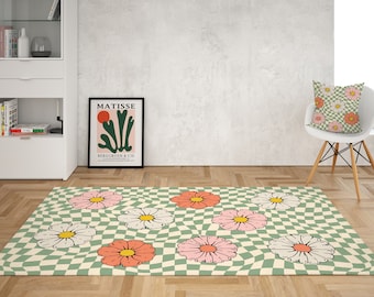 May include: A green and white checkered rug with pink and white flowers. The rug has a retro, 70s style.