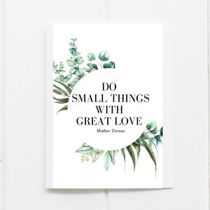 Puede incluir: Una impresión rectangular blanca con la cita "HAZ COSAS PEQUEÑAS CON GRAN AMOR" de la Madre Teresa. El texto es negro, sobre un fondo blanco, y está enmarcado por ilustraciones botánicas verdes y blancas.