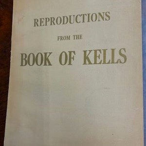 May include: A vintage book cover with the title "Reproductions from the Book of Kells" in gold lettering on a cream background.