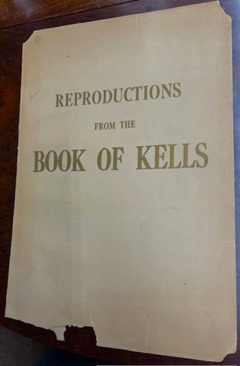 May include: A vintage book cover with the title "Reproductions from the Book of Kells" in gold lettering on a cream background.