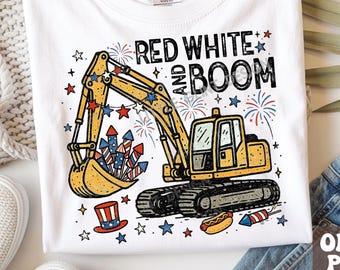 May include: A white t-shirt featuring a yellow excavator graphic with red, white, and blue fireworks, stars, a top hat, and a hot dog. The text reads RED WHITE AND BOOM. The shirt includes a Gildan brand label at the inner neckline.