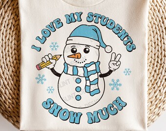 May include: A white t-shirt with a blue snowman graphic and the text "I love my students snow much". The snowman is wearing a blue hat and scarf and holding a pencil.