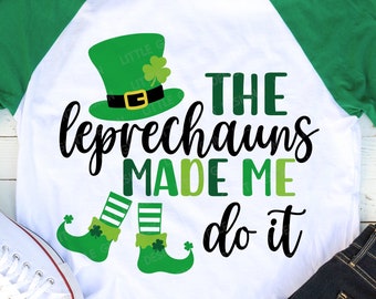 May include: A white t-shirt with a green and black design. The design features a leprechaun with a hat and the text "THE leprechauns MADE ME do it".