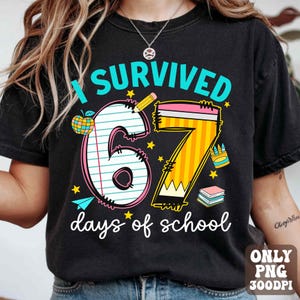 May include: Black t-shirt with the text "I Survived 67 days of school". The design includes a large number 6 and 7, a pencil, an apple, stars, and a stack of books. The shirt is a comfortable, casual style.