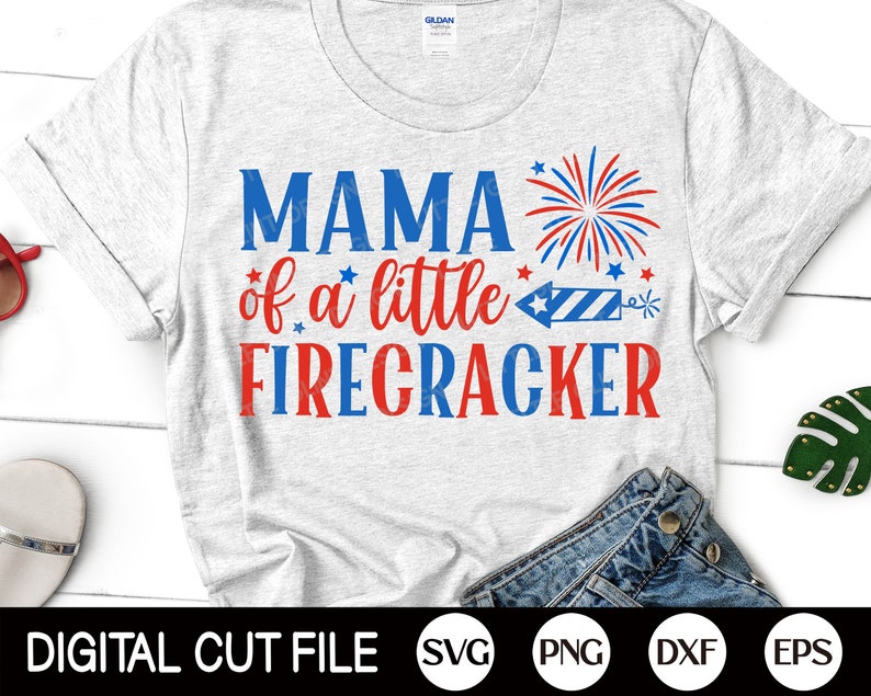 May include: A gray t-shirt with the text "Mama of a little Firecracker" in red and blue lettering. A red, white, and blue firework graphic is above the text.