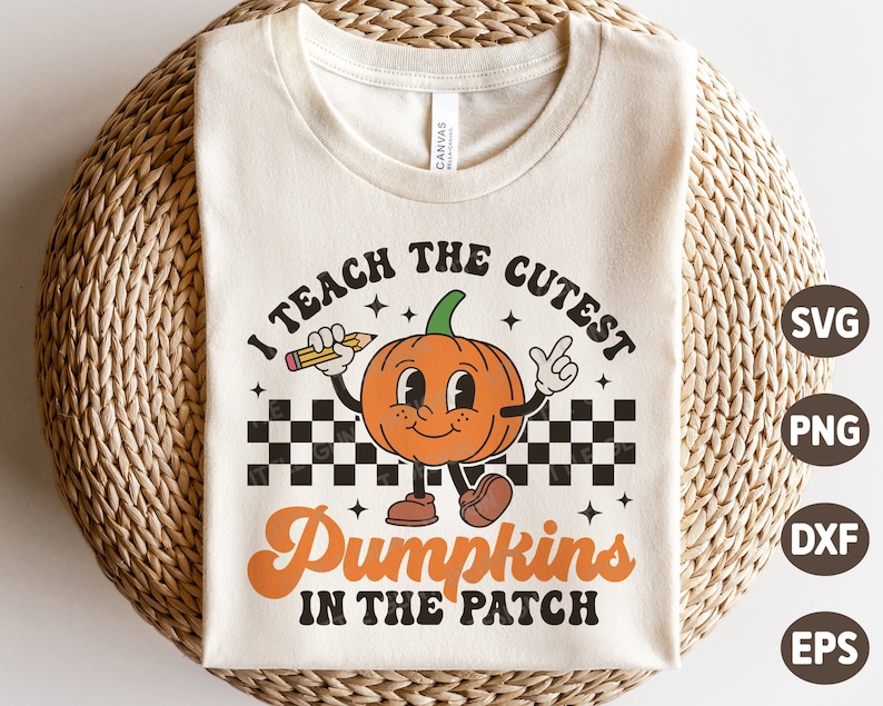 May include: A beige t-shirt with the text "I teach the cutest pumpkins in the patch" in black and orange. A cartoon pumpkin with a smiling face is holding a pencil and wearing a checkered pattern.