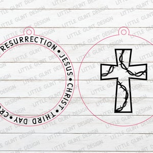 May include: Two round, white wooden ornaments with black text and images. The first ornament has the text "CROSS SACRIFICE &bull; THIRD DAY &bull; RESURRECTION &bull; JESUS CHRIST" in a circle. The second ornament has a black cross with thorns inside a circle.