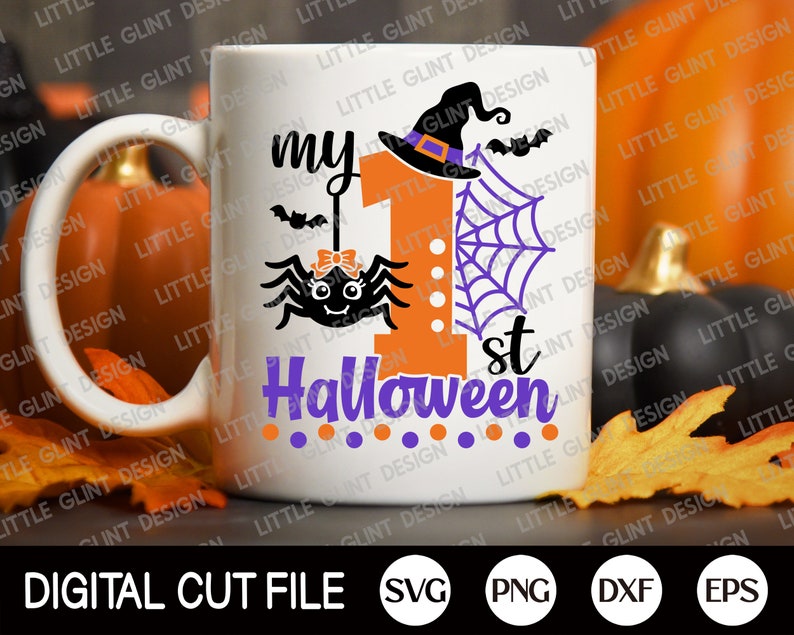 May include: White ceramic mug featuring a design of a spider, a witch's hat, and the text "my 1st Halloween". The design is in orange, purple, and black.