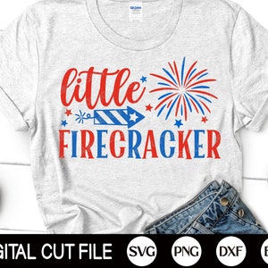 May include: A white t-shirt with the text "little firecracker" in red and blue. A red, white, and blue firework graphic is above the text. The text "DIGITAL CUT FILE" is at the bottom of the image, along with the file types SVG, PNG, DXF, and EPS.