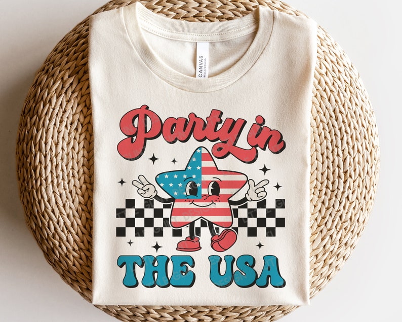 May include: A white t-shirt with a retro-style graphic of a cartoon star wearing a US flag design. The text "Party in the USA" is printed in blue and red letters.