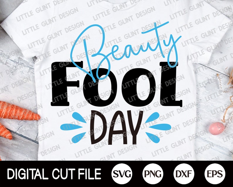 May include: A white t-shirt with a black and blue design that says "Beauty Fool Day" with water droplets. The design is on a white t-shirt with a blue background. The text is in a bold font.