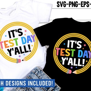 May include: Two t-shirt designs with the text "It's Test Day Y'all!" in a rainbow colored font inside a yellow circle with a pencil design. The text is on a white t-shirt and a black t-shirt.