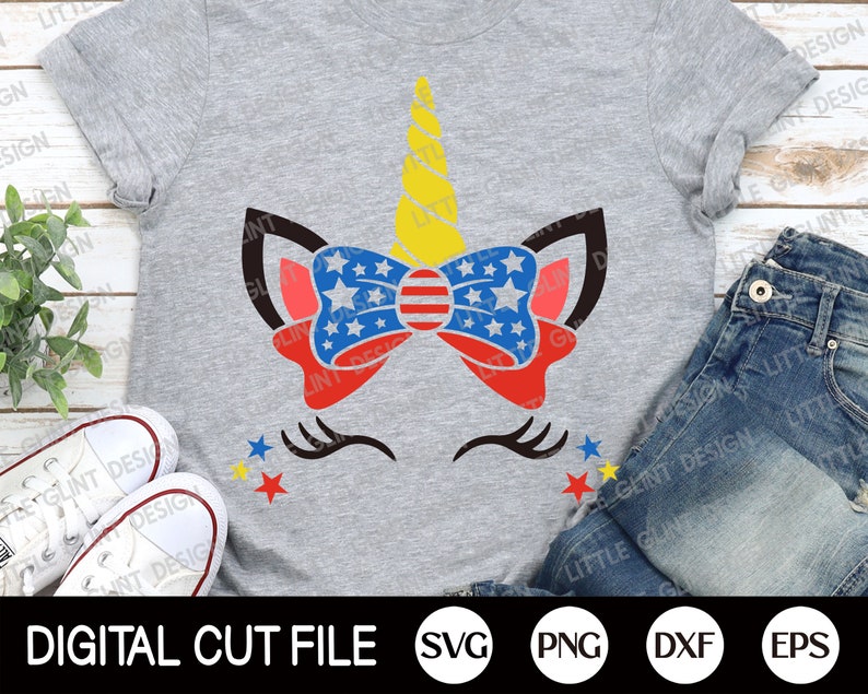 May include: A gray t-shirt with a unicorn design featuring a red, white, and blue bow with stars. The unicorn has a yellow horn and black eyelashes. The text "DIGITAL CUT FILE" is at the bottom of the image, along with the file formats SVG, PNG, DXF, and EPS.